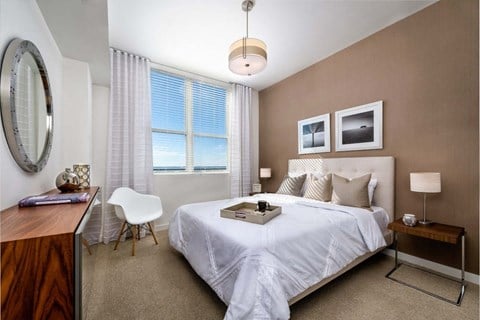 a bedroom with a bed and a desk with a chair at Regatta at New River, Fort Lauderdale, 33301